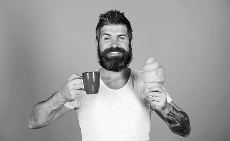 be healthy. Bearded hipster enjoy breakfast drink coffee. Morning tradition concept. Fresh baked croissant. Delicious breakfast. Unhealthy but yummy breakfast. Perfect match. feel hungerの写真素材
