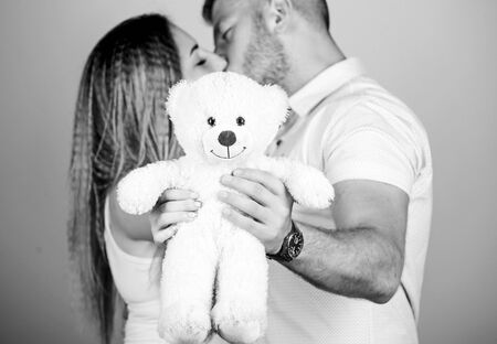 Soft toy teddy bear gift. Guy and girl cuddling. Happy family. Valentines day holiday. Pregnancy concept. Man and woman couple in love. Future parents. Family love. Man and pretty girl in loveの写真素材