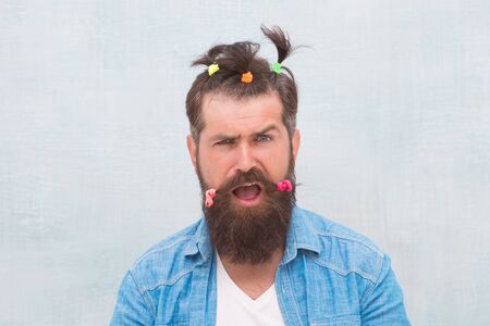 Positive amazed man. Funny portrait of man with funny hairstyle. barbershop and hairdresser. happy fathers day. charismatic hipster. Having fun party. Made for fun. comic faces and emotionsの写真素材