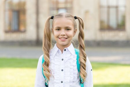 I got new rules. First day of school. Happy schoolgirl urban background. Little schoolgirl back to school. Small schoolgirl wear formal uniform. Charming look of cute schoolgirl. School and eductionの写真素材