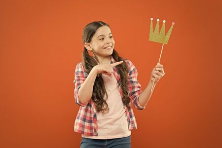 Happiness and joy concept. Fun and humor. Girl child having fun. International childrens day. Superior princess. Nice day to have fun with photo booth props. Playful mood. Golden crown suits herの写真素材