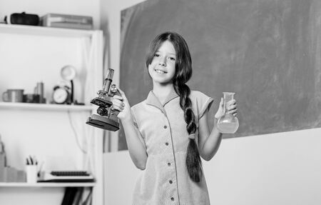 Girl chemistry class testing tube. Chemical reaction. Chemical liquid. Fascinating lesson. Science lesson. School laboratory. Scientific experiment. Small girl with chemical tube. Biology educationの写真素材