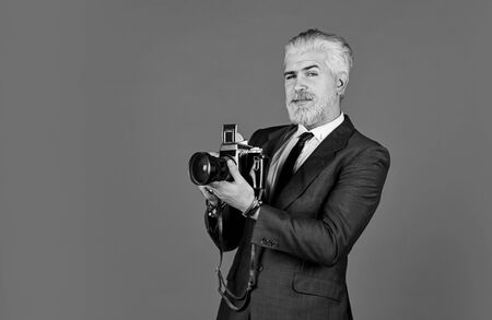 mature man dyed beard and hair. professional photographer make photo. male beauty. capture result of...