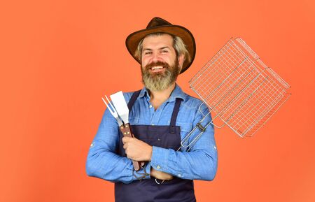 party barbecue bbq. Picnic and barbecue. ready for barbecue party. Culinary concept. summer weekend. hipster hold cooking utensils for barbecue. bearded man chef. Tools for roasting meat outdoorsの写真素材