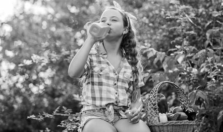 Tasting juice. harvest vitamin. spring market garden. little girl vegetable in basket. Only natural. healthy food for children. happy little farmer. autumn harvest. kid on summer farm. Organic foodの写真素材