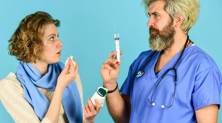 Flu concept. Medical injection. Vaccine development. Man nurse with vaccine in syringe. Doctor use syringe needle vaccination. Dose injection for sick patient girl. Drug injection. Virus pandemicの写真素材