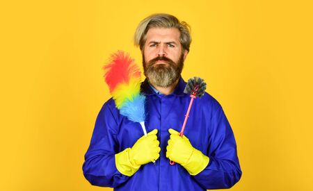 Cleaning apartment. Man use pp duster. Dust allergy. Husband cleaning home. Polypropylene duster. Hipster hold cleaning tool. Cleaning concept. Small duster. Cleaning service. Housekeeping dutiesの写真素材