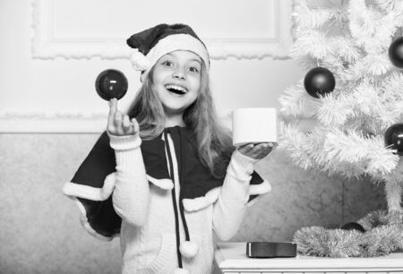 Santa bring her gift. Unpacking christmas gift. Happy childhood concept. Winter holiday tradition. Kid with christmas present. Reason children love christmas. Girl celebrate christmas open gift boxの写真素材