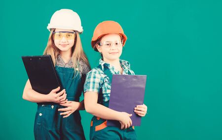 small girls repairing together in workshop. Child care development. Future profession. Builder engineer architect. Kid worker in hard hat. Tools to improve yourself. Repair. Trust to professionalsの写真素材
