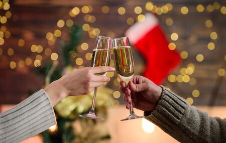 Cheers concept. New year tradition. Glass filled sparkling wine or champagne. Having nice time. Toast. Glass of champagne. Champagne couple glasses. Merry christmas. Almost midnight. Alcohol drink.の写真素材