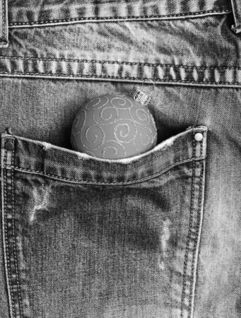 Celebrate christmas. Ball decoration for christmas tree pocket of denim pants. Winter holiday...