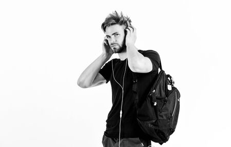 Rhythmic melody concept. Man tousled hairstyle wear plastic earphones gadget. Enjoy music everywhere you go. Youth music taste. Download music application. Student handsome guy listening musicの写真素材