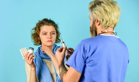 Flu concept. Medical injection. Man nurse with coronavirus vaccine in syringe. Doctor use syringe needle vaccination. Dose injection for sick patient girl. Drug injection. Vaccine developmentの写真素材