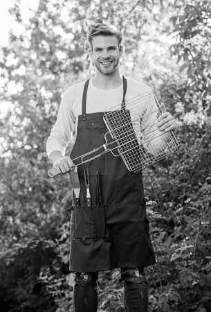 Healthy meal. Recipe grill. Methods grilling. Bbq concept. Backyard barbeque party. Man hold grilling grid. Grilling food. Tools for roasting meat outdoors. Picnic concept. Handsome guy cooking foodの写真素材