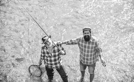 succeeding together. summer weekend. mature men fisher. hobby and sport activity. Trout bait. father...