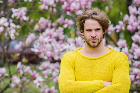 Botanical garden. Tender flowers. Hipster enjoy blossom. Springtime concept. Man flowers background defocused. Spring beauty. Botany and nature. Freshness and awakening. Guy relax in flowers parkの写真素材