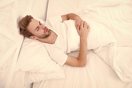 man sleep in bed. early morning wakeup. man sleeping white bedroom. cosy weekend at home. time to...