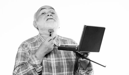 Shaving facial hair. Experienced barber appreciate high quality barber equipment. Barber self care. Grooming beard set. Barbershop concept. Man senior bearded handsome barber use tool styling beardの写真素材