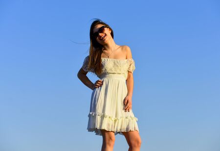 Romantic mood. pretty woman wear sunglasses. female summer fashion. sensual beauty in white dress outdoor. spring mood. sexy girl with brunette hair on sky background. perfect sunset or sunriseの写真素材