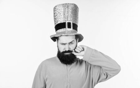He twirling his moustache around his finger. Irish man with beard wearing green. Happy saint patricks day. Hipster in leprechaun hat and costume. Bearded man celebrating saint patricks dayの写真素材