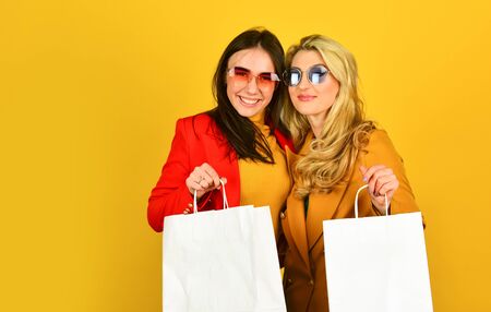 Black friday. Women in spring jacket. Promoting product. Girls shopping. Shopping mall. Luxury...