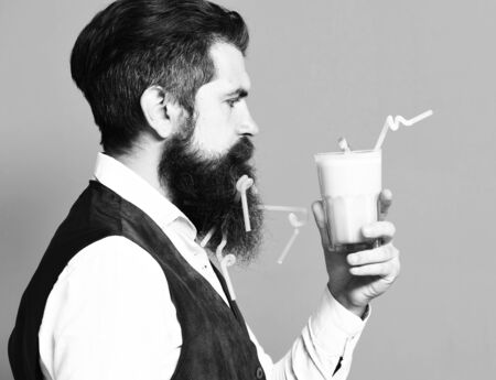 serious handsome bearded man on red studio backgroundの写真素材