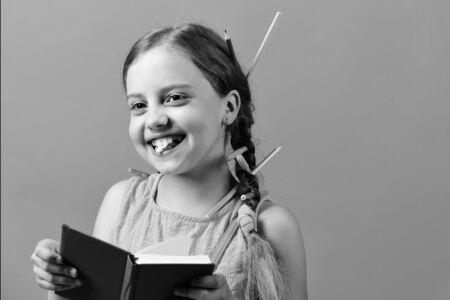 School girl with happy smiling face isolated on blue backgroundの写真素材