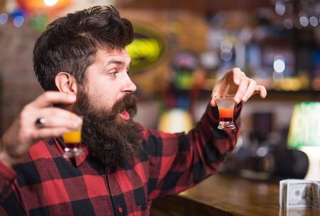 Man with cheerful face sit alone at bar counter.の写真素材