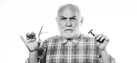 It is just unbelievable. barbershop concept. shaving accessories. unshaven old man has moustache and beard. scissors cut and brush hair. mature bearded man isolated on white. shaving razor blade kitの写真素材