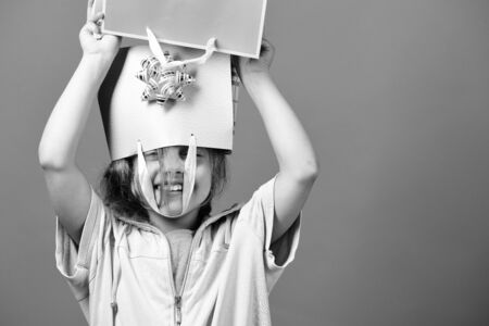 Kid with happy smiling face and messy hairdo does shoppingの写真素材