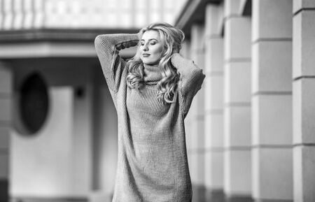 Beauty in style. cashmere woolen sweater. warm oversized clothes. sexy woman sunny weather outdoor. free style comfortable. autumn fashion. blond girl make up fall outfit. girl soft knitwear dressの写真素材