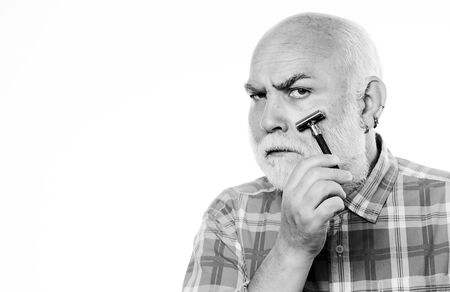 shaving razor blade tool kit. mature bearded man isolated on white. unshaven old man has moustache and beard. cut and brush hair. barbershop concept. shaving accessories. copy spaceの写真素材