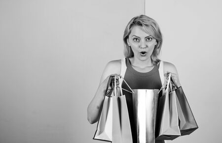 Clothing store. present packages for holiday preparation. summer discount. special offer on black friday. shop closeout. surprised woman shopper. big sale. female shopaholic hold shopping bagsの写真素材