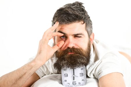 Tired man trying to open his eyes in morning.の写真素材