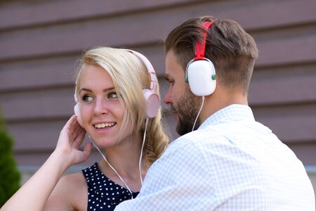 Couple in love listening music in headphones.の写真素材