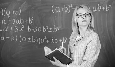 Woman teaching near chalkboard in classroom. Effective teaching involve acquiring relevant knowledge...