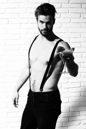 handsome bearded macho sexy man on brick wall backgroundの写真素材