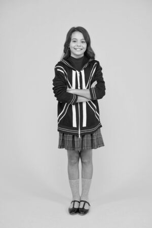 british school in england. vacation in great britain. travel concept. Union Jack Flag. small girl uniform. kid with english flag on jacket. go study to england. learn english languageの写真素材