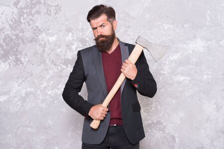 Threat to debtors. Debt collection is process of pursuing payments of debts owed by individuals or businesses. Brutal bearded man with axe. Collection agency or debt collector. Businessman with axの写真素材
