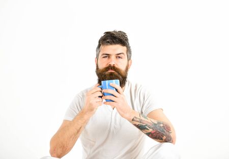 Man with sleepy face try to awake with coffee.の写真素材