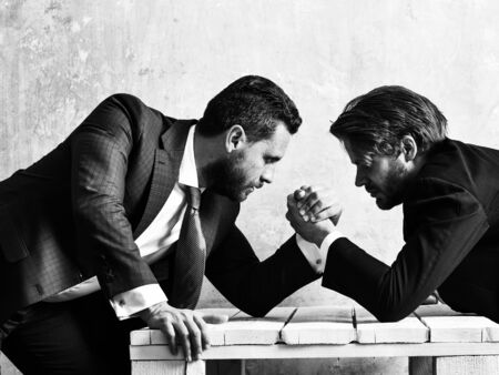 opposition of businessmen, arm wrestling and power, business situationの写真素材