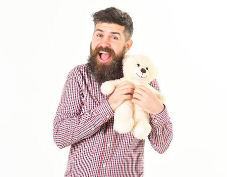 Hipster cares about teddy bear. Man holds teddy bearの写真素材