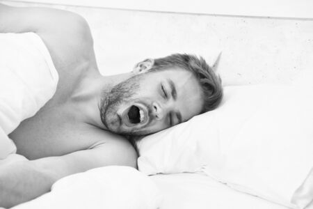 asleep and awake. sexy man sleep in bed. good morning. sweet dreams. male health and bachelor lifestyle. man fast sleep. Relaxing in bedroom. energy and tiredness.の写真素材