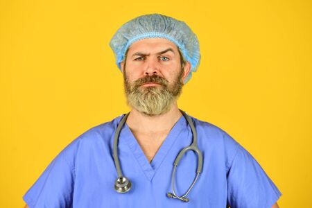 family doctor. Physician with confident face ready to diagnose. serious nurse in blue uniform. outbreak of a new coronavirus. cases of coronavirus infection. Nurse man use phonendoscopeの写真素材