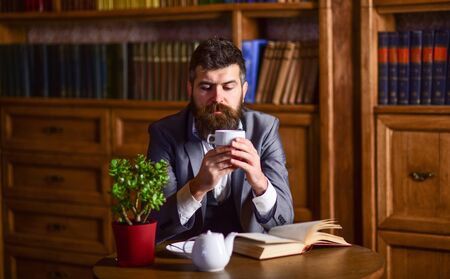 Man with calm face enjoys hot beverage.の写真素材