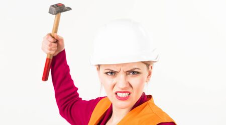 Feminism concept. Woman with angry face holds hammer,の写真素材