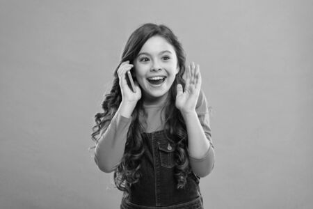 Amazing story. happy little girl having phone talk. modern life communication. kid shopping online. call service use technology. school girl talking with friend. kid speak on phone. conversationの写真素材