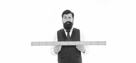 bearded man with ruler isolated on white. Measuring his height with ruler. university teacher hold ruler. size and length measurement. school stem disciplines. back to school. Measuring his beardの写真素材