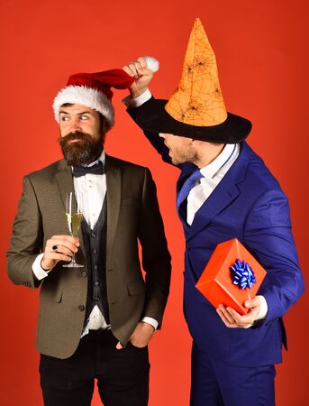 Businessmen with curious faces pose on holiday partyの写真素材