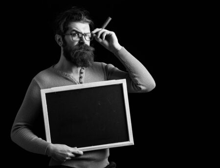 serious hipster in glasses on black background, copy spaceの写真素材